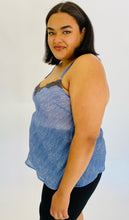 Load image into Gallery viewer, Side view of a size 2X Savage x Fenty light blue "denim" patterned camisole with black lace bust detail styled with black pants on a size 18 model.