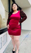 Load image into Gallery viewer, Additional full-body front view of a red velvet bodycon mini dress with black velvet puff sleeves with red sequins styled with black heels on a size 14/16 model.