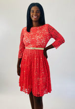 Load image into Gallery viewer, Additional front view of a size 16 Eliza J coral lace long sleeve pleated midi dress with cream lining underneath and cream skinny belt on a size 12 model.