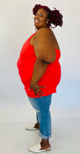 Load image into Gallery viewer, Full-body side view of a size 6 Torrid coral red v-neck halter tank styled with light wash jeans and white slides on a size 26/28 model.