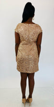 Load image into Gallery viewer, Full-body back view of this size 14 Jessica Howard gold sequin mini dress with high neck and cap sleeves styled with tan patent leather heels on a size 12 model.