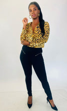 Load image into Gallery viewer, Full-body front view of a size XL Cushnie 100% silk leopard print long sleeve bodysuit styled with black tapered slacks and black pumps on a size 12 model.
