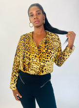 Load image into Gallery viewer, Additional front view of a size XL Cushnie 100% silk leopard print long sleeve bodysuit styled with black tapered slacks on a size 12 model.