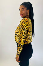 Load image into Gallery viewer, Side view of a size XL Cushnie 100% silk leopard print long sleeve bodysuit styled with black tapered slacks on a size 12 model.
