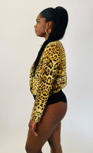 Load image into Gallery viewer, Side  view of a size XL Cushnie 100% silk leopard print long sleeve bodysuit on a size 12 model.
