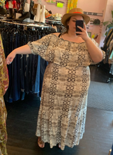Load image into Gallery viewer, Full-body front view showing off the flutter fold-over detail of a size 22 Eloquii brown and cream off-the-shoulder foldover maxi dress styled with a brown and orange wicker boater hat on a size 24 model.