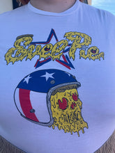 Load image into Gallery viewer, Close up view of a size XL &quot;Evel Pie&quot; Evel Knievel pizza t-shirt styled with brown shorts on a size 22/24 model. The photo was taken outside in natural lighting.
