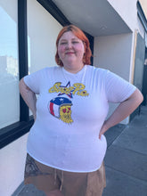 Load image into Gallery viewer, Front view of a size XL &quot;Evel Pie&quot; Evel Knievel pizza t-shirt styled with brown shorts on a size 22/24 model. The photo was taken outside in natural lighting.
