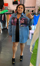 Load image into Gallery viewer, Full-body front view of a size XL Lanvin painted Batman denim button-up styled open over a black mini dress on a size 18/20 model. The photo is taken inside under overhead lighting..
