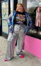 Load image into Gallery viewer, Front view of a size 2X DOM brand black 100% cotton t-shirt with a graphic of a cartoon car that reads &quot;Supreme Racing, Pure Power&quot; in racetrack-style font, styled tucked into silver sequin trousers, with an iridescent puffer jacket and pink sneakers on a size 22/24 model.

