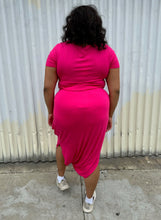 Load image into Gallery viewer, Full-body back view of a size 2 Fashion to Figure two piece hot pink cropped tee and tie-detail maxi skirt set styled with white sneakers on a size 18/20 model. The photo is taken outside in natural lighting.
