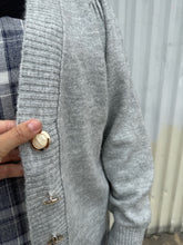 Load image into Gallery viewer, Close view of the pearl and gold buttons on a size 22/24 Eloquii light gray cardigan with pearl &amp; gold buttons styled over a blue &amp; white plaid jumpsuit on a size 18/20 model. The photo was taken outside in natural lighting.
