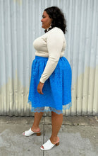 Load image into Gallery viewer, Full-body side view of a size 1/2X Beauciel bright baby blue circle skirt with lace overlay styled with a cream sweater and white mules on a size 18/20 model. The photo was taken outside in natural lighting.

