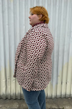 Load image into Gallery viewer, Side view of a size 4 Fashion to Figure x Gabi Fresh off-white and maroon 70s floral blazer with a single button closure styled over a turtleneck and lightwash denim on a size 22/24 model. The photo was taken outside in natural lighting.
