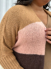 Load image into Gallery viewer, Close up view on the knit and striped pattern of a size XL (fits comfy up to 22) Free People brown, cream, pink, and purple striped longline open knit cardigan sweater styled open on a size 18/20 model. The photo was taken outside in natural lighting.
