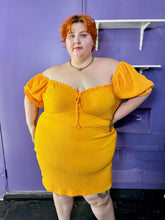 Load image into Gallery viewer, Front view of a size 24 Wednesday&#39;s Girl golden yellow textured off-shoulder puff sleeve mini dress with sweetheart neckline on a size 22/24 model. The photo was taken inside in fluorescent and natural lighting.
