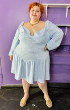 Load image into Gallery viewer, Full-body front view of a size 24 ASOS baby blue and white gingham off-shoulder pointed waistline mini dress on a size 22/24 model. The photo was taken inside in fluorescent and natural lighting.
