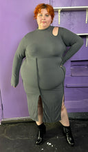 Load image into Gallery viewer, Additional full-body front view of a size 3X Finesse dark gray ribbed long sleeve midi dress with a shoulder cut out, two front slits, and contrast stitching details styled with patent leather black boots on a size 22/24 model. The photo was taken inside in flourescent and natural lighting.
