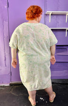Load image into Gallery viewer, Full-body back view of a size XXL (fits up to 24 comfy) H&amp;M light green and white acid wash tie dye caftan styled with tan slides on a size 22/24 model. The photo was taken inside under fluorescent and natural lighting.
