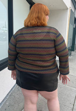 Load image into Gallery viewer, Back view of a size 22/24 vintage Venezia textured green, blue, and brown striped long sleeve top styled over a black pleater mini skirt on a size 22/24 model. The photo is taken outside in natural lighting.
