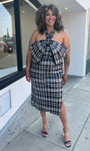 Load image into Gallery viewer, Additional full-body front view of a size 24 Eloquii black and white sequin plaid halter neckline with oversized bow detail at the bust styled with black and clear heels on a size 16/18 model.
