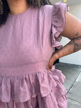 Load image into Gallery viewer, Close up view of the floral burnout print on this size 3X JessaKae mauve ruffle-tiered midi dress with burnout eyelet pattern and high neckline styled with bright purple heels on a size 16/18 model.
