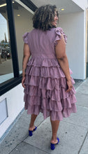 Load image into Gallery viewer, Full-body back view of a size 3X JessaKae mauve ruffle-tiered midi dress with burnout eyelet pattern and high neckline styled with bright purple heels on a size 16/18 model.

