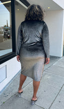 Load image into Gallery viewer, Full-body back view of a size 2X Rachel Roy metallic brown-gold velvet long sleeve bodycon midi dress with ruching at the sides styled with black and clear heels on a size 16/18 model. The photo is taken outside in natural lighting.
