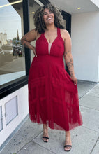 Load image into Gallery viewer, Additional full-body front view of a size 20 City Chic red lace and mesh halter-style gown with a tan mesh bust panel styled with black and clear heels on a size 16/18 model. The photo is taken outside in natural lighting.
