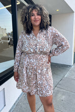 Load image into Gallery viewer, Front view of a size 1/2X Brenin Newport vintage tan and white sketched floral collared a-line dress with a fabric belt on a size 16/18 model. The photo is taken outside in natural lighting.

