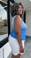 Load image into Gallery viewer, Side view of a size 1/2X light blue to dark blue ombre popcorn-style tank top styled over some cream denim shorts on a size 16/18 model. The photo is taken outside in natural lighting.
