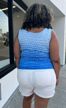 Load image into Gallery viewer, Back view of a size 1/2X light blue to dark blue ombre popcorn-style tank top styled over some cream denim shorts on a size 16/18 model. The photo is taken outside in natural lighting.

