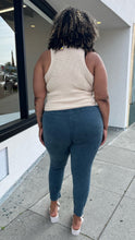 Load image into Gallery viewer, Full-body back view of a pair of size XXXL Knix slate blue tapered drawstring pants styled with a cream tank and white heels on a size 16/18 model. The photo is taken outside in natural lighting.
