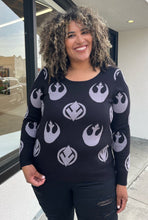 Load image into Gallery viewer, Front view of a size 2 Her Universal black and gray Star Wars Jedi and Rebel Alliance symbol sweater styled with black distressed jeans on a size 16/18 model. The photo is taken outside in natural lighting.
