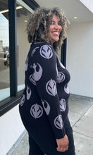 Load image into Gallery viewer, Side view of a size 2 Her Universal black and gray Star Wars Jedi and Rebel Alliance symbol sweater styled with black distressed jeans on a size 16/18 model. The photo is taken outside in natural lighting.
