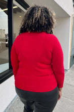 Load image into Gallery viewer, Back view of a size 1X Talbots red cashmere turtleneck sweater styled with black leather pants on a size 16/18 model. The photo is taken outside in natural lighting.
