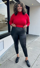 Load image into Gallery viewer, Front view of black Avex Les Filles Skinny Pants on a size 16/18 model. The pants have a thick waistband and the model is wearing a red turtleneck sweater with them.  
