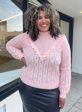 Load image into Gallery viewer, Front view of a soft pink Eloquii sweater in a size 18/20 on a size 16/18 model that has their hand on their hip. 
