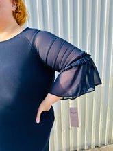 Load image into Gallery viewer, Close up on the sheer tiered sleeve of a size 2X Nina Leonard navy blue mini dress with sheer mesh tiered sleeves. The photo is taken outside in natural lighting.
