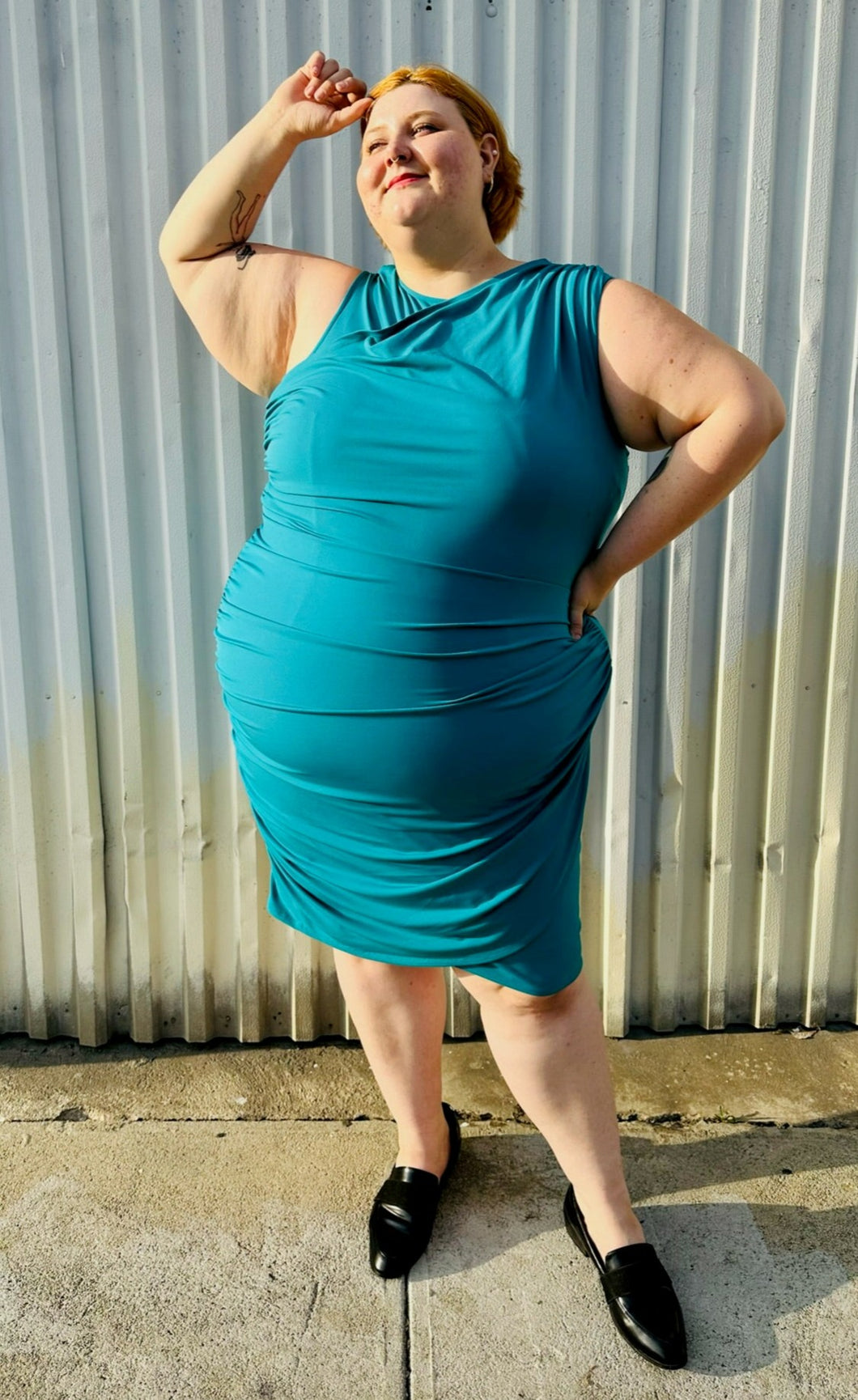 Full-body front view size 24 Lane Bryant teal sleeveless midi dress styled with black loafer slides on a size 22/24 model. The photo is taken outside in natural lighting.