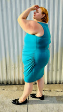 Load image into Gallery viewer, Full-body side view size 24 Lane Bryant teal sleeveless midi dress styled with black loafer slides on a size 22/24 model. The photo is taken outside in natural lighting.
