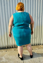 Load image into Gallery viewer, Full-body back view size 24 Lane Bryant teal sleeveless midi dress styled with black loafer slides on a size 22/24 model. The photo is taken outside in natural lighting.
