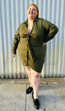 Load image into Gallery viewer, Additional full-body front view of a size 4 Fashion to Figure army green twist-front collared shirt dress styled with black slide loafers on a size 22/24 model. The photo is taken outside in natural lighting.

