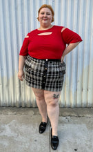 Load image into Gallery viewer, Full-body front view of a size 30/32 Ashley Stewart red cut-out blouse with shoulder, sleeve, and bust cut-outs styled tucked into a sequin mini skirt on a size 22/24 model. The photo is taken outside in natural lighting.
