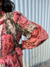 Load image into Gallery viewer, Close up view of the patchwork floral pattern of a 18 Rachel Parcell pink, coral, brown, and cream patchwork floral pattern with pleated skirt, pussy bow, and bishop sleeve on a size 18/20 model. The photo is taken outside in natural lighting.
