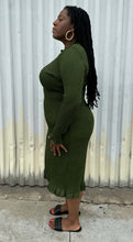 Load image into Gallery viewer, Full-body side view of a size XXL Rachel Parcell forest green all-over smocking long sleeve midi dress with mock neckline and ruffle hem styled with black slides on a size 14/16 model. The photo is taken outside in natural lighting.
