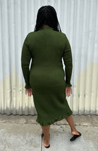 Load image into Gallery viewer, Full-body back view of a size XXL Rachel Parcell forest green all-over smocking long sleeve midi dress with mock neckline and ruffle hem styled with black slides on a size 14/16 model. The photo is taken outside in natural lighting.
