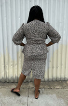 Load image into Gallery viewer, Full-body back view of a size 12/14 Alexis Fashion Inc. vintage white and black abstract pattern sheath dress with v-neck and peplum details styled with black heels on a size 14/16 model. The photo is taken outside in natural lighting.
