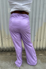 Load image into Gallery viewer, Back view of a pair of size 1X Finesse lavender leather wide leg pants styled with a white crop and black slides on a size 14/16 model. The photo is taken outside in natural lighting.
