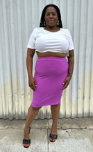 Load image into Gallery viewer, Full-body front view of a size 14/16 Eloquii light purple ribbed pencil skirt styled with black heels and a white top on a size 14/16 model. The photo was taken outside in natural lighting.
